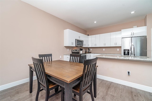 1229 Zinnia Loop, Labelle, FL 33935 - dining area with baseboards, light wood finished floors, and recessed lighting