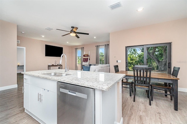 1229 Zinnia Loop, Labelle, FL 33935 - kitchen with stainless steel dishwasher, a sink, baseboards, light wood-type flooring, and healthy amount of natural light