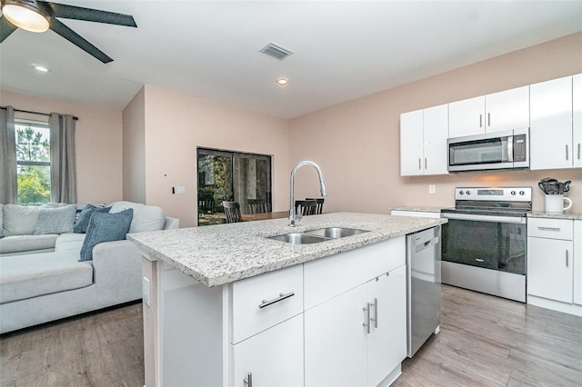 1229 Zinnia Loop, Labelle, FL 33935 - kitchen featuring appliances with stainless steel finishes, a sink, open floor plan, light wood-style flooring, and recessed lighting