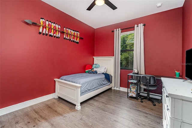 1229 Zinnia Loop, Labelle, FL 33935 - bedroom featuring an office area, wood finished floors, baseboards, and ceiling fan