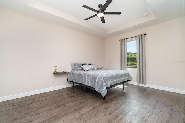 1229 Zinnia Loop, Labelle, FL 33935 - bedroom with a tray ceiling, wood finished floors, baseboards, and ceiling fan