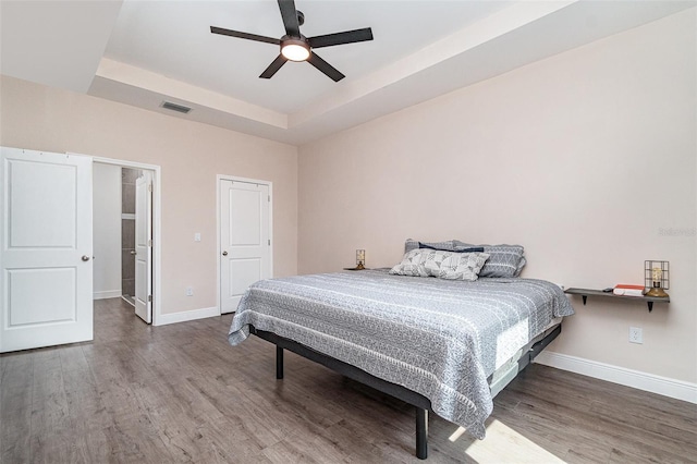 1229 Zinnia Loop, Labelle, FL 33935 - bedroom with wood finished floors, baseboards, a tray ceiling, and ceiling fan