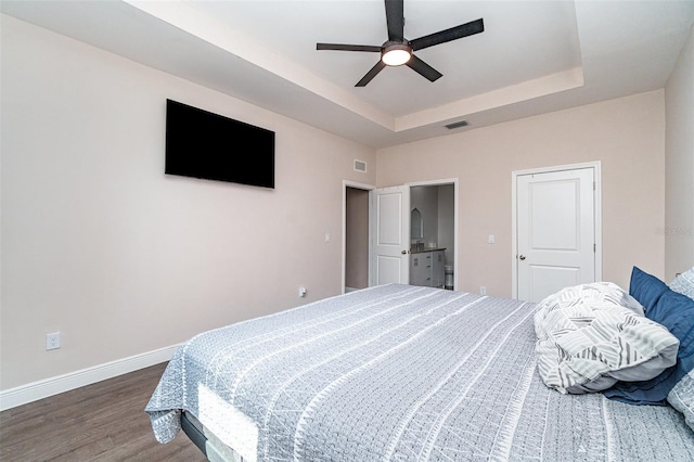 1229 Zinnia Loop, Labelle, FL 33935 - bedroom with wood finished floors, baseboards, a tray ceiling, and ceiling fan