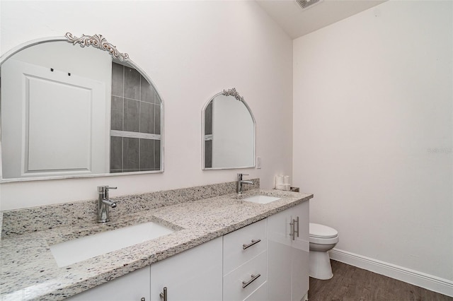 1229 Zinnia Loop, Labelle, FL 33935 - full bathroom with toilet, wood finished floors, double vanity, and baseboards