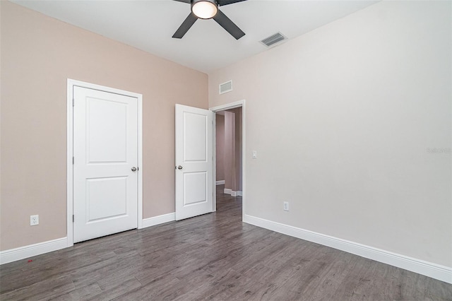 1229 Zinnia Loop, Labelle, FL 33935 - unfurnished bedroom featuring wood finished floors, baseboards, and a ceiling fan