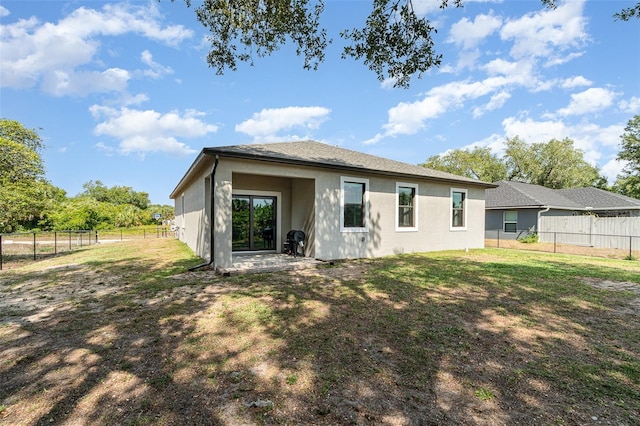 1229 Zinnia Loop, Labelle, FL 33935 - back of property with stucco siding and a patio