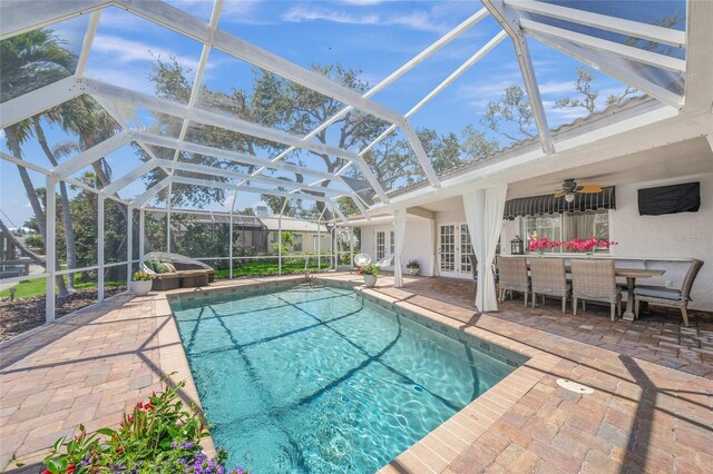 572 Commonwealth Ln, Sarasota, FL 34242 - swimming pool with french doors, a patio, ceiling fan, and a lanai