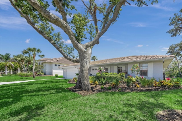 572 Commonwealth Ln, Sarasota, FL 34242 - ranch-style home featuring a garage, a tile roof, stucco siding, and a front yard