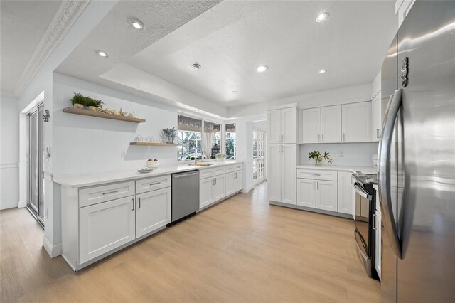 572 Commonwealth Ln, Sarasota, FL 34242 - kitchen featuring stainless steel appliances, light wood finished floors, open shelves, white cabinetry, and recessed lighting
