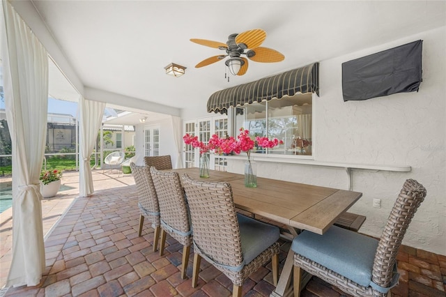 572 Commonwealth Ln, Sarasota, FL 34242 - dining space with brick flooring, a textured wall, and a ceiling fan