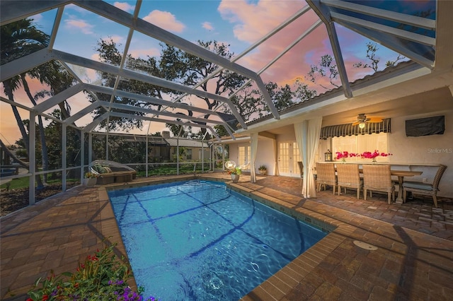 572 Commonwealth Ln, Sarasota, FL 34242 - swimming pool with french doors, a patio area, and a lanai