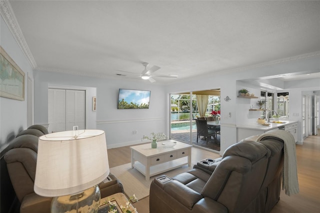 572 Commonwealth Ln, Sarasota, FL 34242 - living area with ceiling fan, light wood-type flooring, ornamental molding, and baseboards
