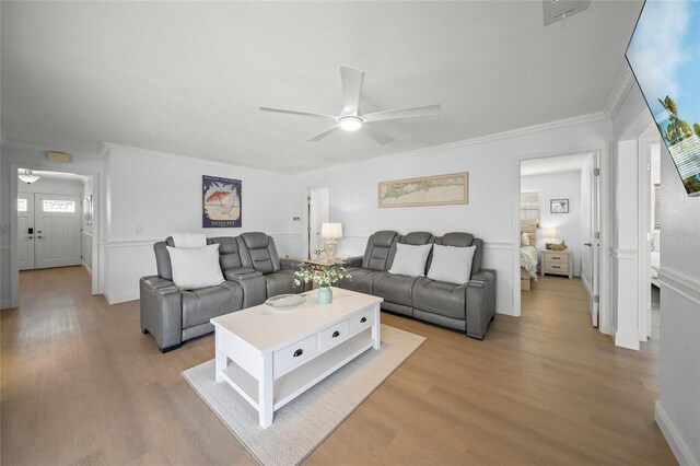 572 Commonwealth Ln, Sarasota, FL 34242 - living area featuring a ceiling fan, light wood-style flooring, ornamental molding, and baseboards