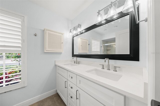 572 Commonwealth Ln, Sarasota, FL 34242 - full bathroom featuring double vanity, a shower stall, tile patterned floors, and baseboards