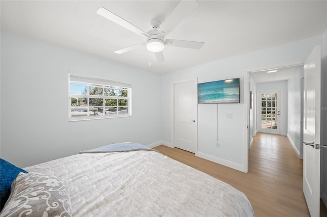 572 Commonwealth Ln, Sarasota, FL 34242 - bedroom with wood finished floors, multiple windows, baseboards, and ceiling fan