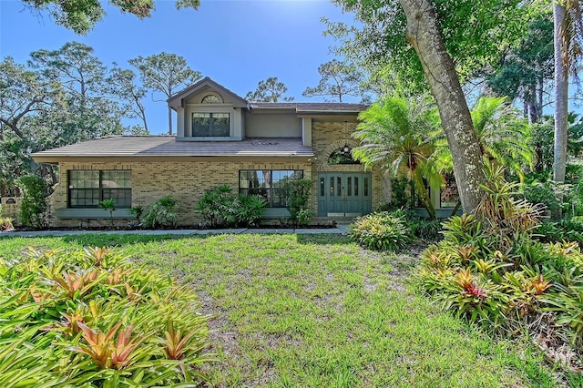 4917 Leatha Ln, Sarasota, FL 34232 - view of front facade with brick siding and a front lawn