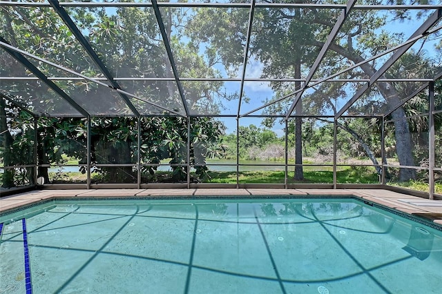 4917 Leatha Ln, Sarasota, FL 34232 - outdoor pool featuring glass enclosure and view of wooded area
