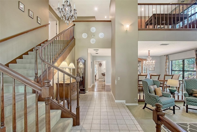 4917 Leatha Ln, Sarasota, FL 34232 - entrance foyer featuring a chandelier, a high ceiling, stairway, tile patterned flooring, and baseboards