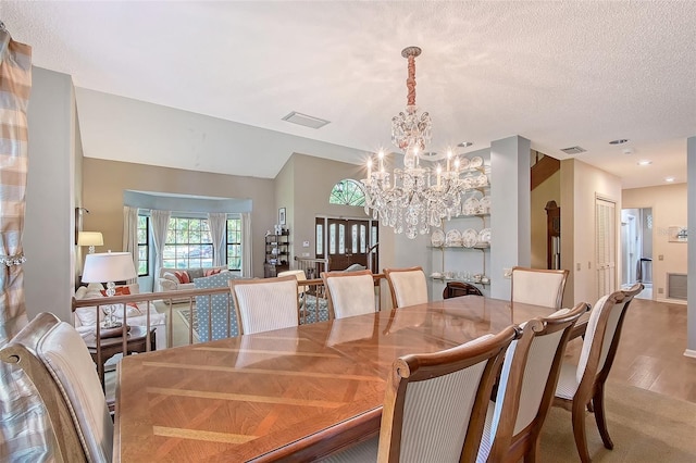 4917 Leatha Ln, Sarasota, FL 34232 - dining space with a chandelier and wood finished floors