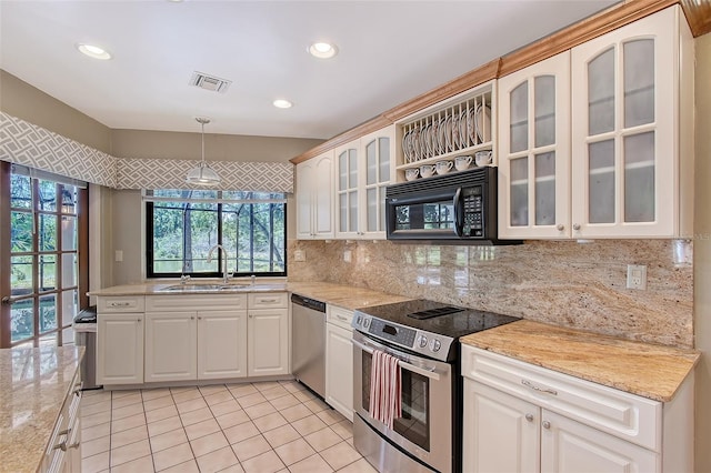 4917 Leatha Ln, Sarasota, FL 34232 - kitchen featuring stainless steel appliances, a sink, backsplash, recessed lighting, and light tile patterned flooring