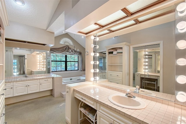 4917 Leatha Ln, Sarasota, FL 34232 - bathroom featuring two vanities, lofted ceiling, and a textured ceiling