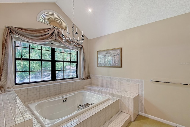 4917 Leatha Ln, Sarasota, FL 34232 - bathroom with a chandelier, a jetted tub, vaulted ceiling, and baseboards