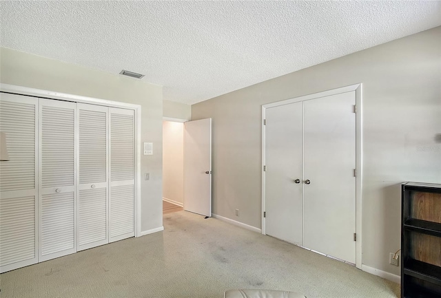 4917 Leatha Ln, Sarasota, FL 34232 - unfurnished bedroom featuring light colored carpet, baseboards, and a textured ceiling