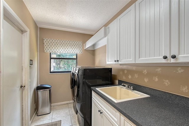 4917 Leatha Ln, Sarasota, FL 34232 - laundry room with independent washer and dryer, cabinet space, a textured ceiling, light tile patterned flooring, and baseboards
