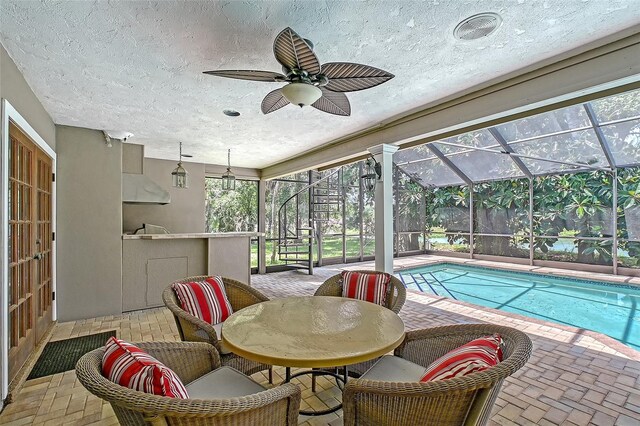 4917 Leatha Ln, Sarasota, FL 34232 - outdoor pool with a patio area, a ceiling fan, and glass enclosure