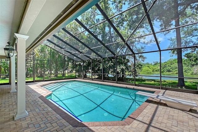 4917 Leatha Ln, Sarasota, FL 34232 - swimming pool featuring a water view, a lanai, a diving board, a patio, and view of wooded area