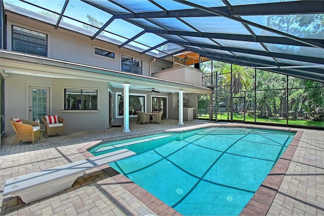4917 Leatha Ln, Sarasota, FL 34232 - outdoor pool featuring ceiling fan, a patio area, and glass enclosure