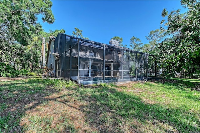 4917 Leatha Ln, Sarasota, FL 34232 - rear view of house with a chimney and a lanai