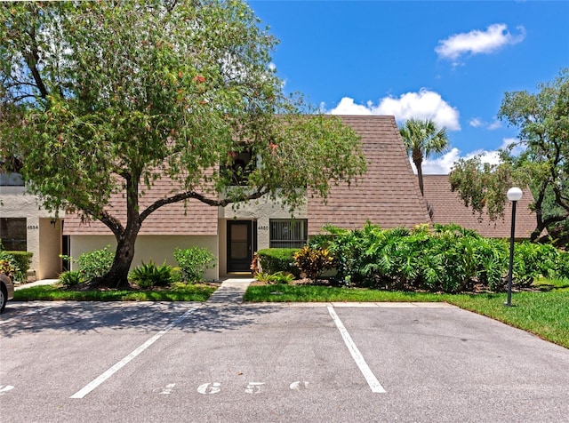 4650 Ringwood Mdw Unit 37, Sarasota, FL 34235 - view of front of property featuring uncovered parking and stucco siding