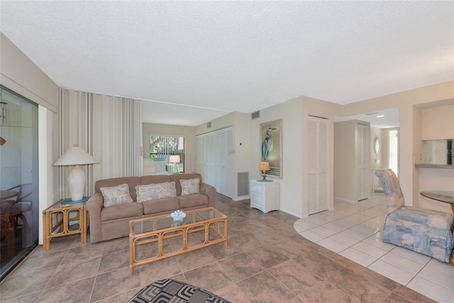 4650 Ringwood Mdw Unit 37, Sarasota, FL 34235 - living room featuring a textured ceiling and baseboards