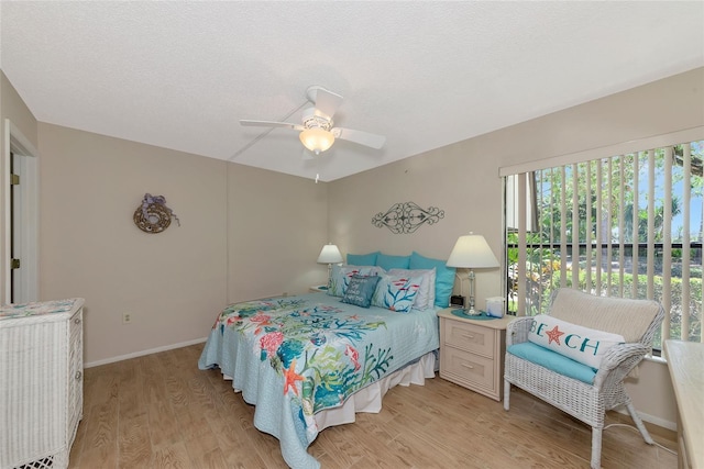 4650 Ringwood Mdw Unit 37, Sarasota, FL 34235 - bedroom with light wood-style flooring, a ceiling fan, and baseboards
