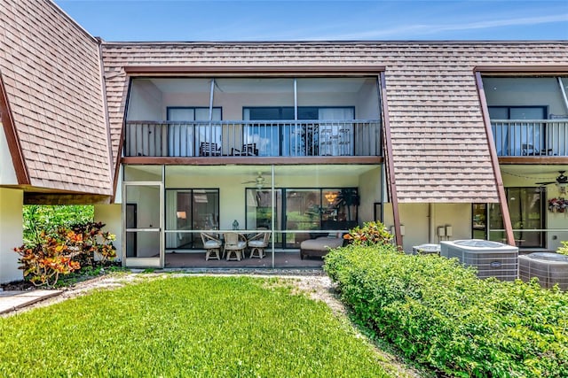 4650 Ringwood Mdw Unit 37, Sarasota, FL 34235 - rear view of house with central AC unit, a balcony, a lawn, and stucco siding
