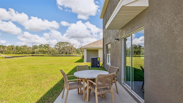 12047 Lansing Gln, Parrish, FL 34219 - view of grassy yard featuring outdoor dining area, cooling unit, and a patio