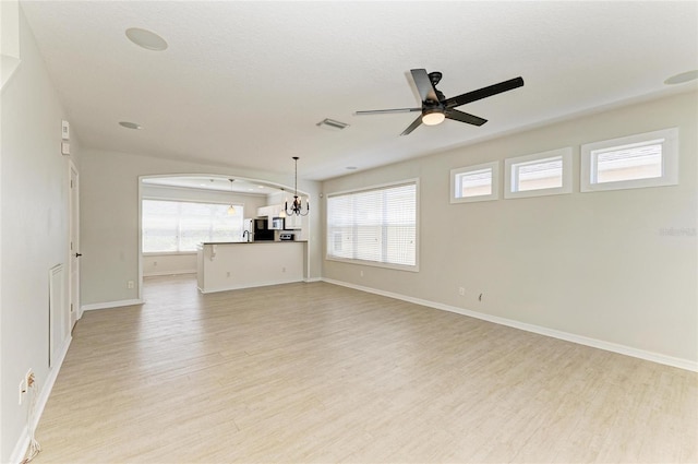5420 River Sound Ter, Bradenton, FL 34208 - unfurnished living room with light wood-style floors, ceiling fan, a chandelier, and baseboards