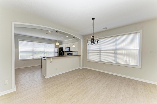 5420 River Sound Ter, Bradenton, FL 34208 - kitchen with appliances with stainless steel finishes, a chandelier, light wood-style floors, white cabinetry, and recessed lighting