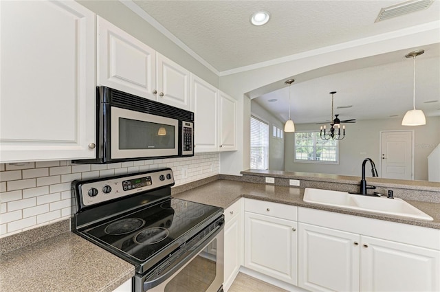 5420 River Sound Ter, Bradenton, FL 34208 - kitchen with appliances with stainless steel finishes, a sink, a chandelier, tasteful backsplash, and white cabinetry