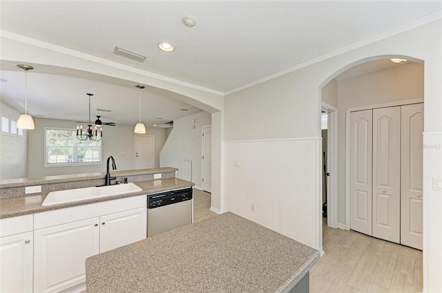 5420 River Sound Ter, Bradenton, FL 34208 - kitchen with dishwasher, a sink, arched walkways, white cabinetry, and light wood-style flooring
