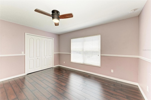 5420 River Sound Ter, Bradenton, FL 34208 - unfurnished bedroom with baseboards, a closet, wood finished floors, and a ceiling fan
