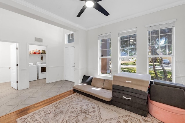 6032 36th Ct E, Ellenton, FL 34222 - living room featuring washing machine and clothes dryer, crown molding, light wood finished floors, ceiling fan, and baseboards