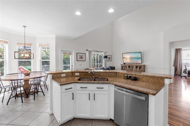 6032 36th Ct E, Ellenton, FL 34222 - kitchen with dishwasher, a sink, a textured ceiling, stone countertops, and decorative light fixtures