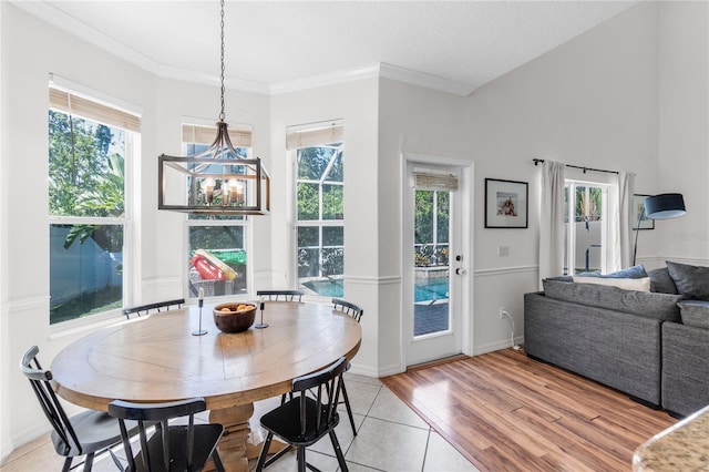 6032 36th Ct E, Ellenton, FL 34222 - dining space with plenty of natural light, light wood-style flooring, ornamental molding, and baseboards