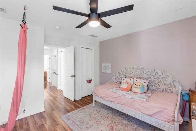 6032 36th Ct E, Ellenton, FL 34222 - bedroom featuring wood finished floors, ceiling fan, a closet, and baseboards