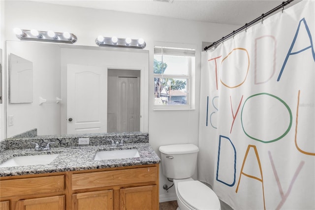 6032 36th Ct E, Ellenton, FL 34222 - bathroom with double vanity, toilet, a shower with curtain, and baseboards