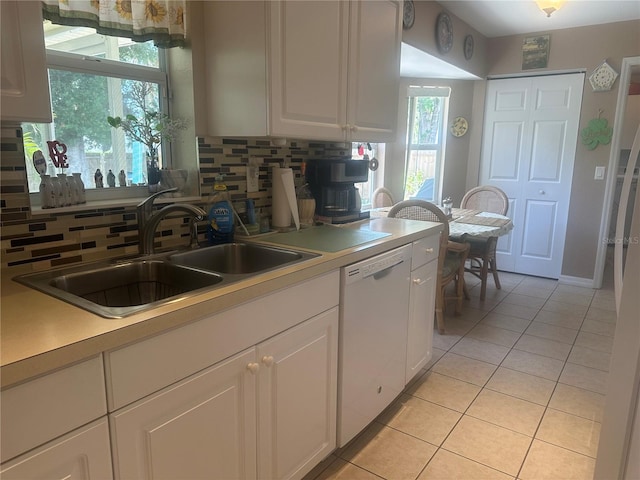 4027 Allure Ln, North Port, FL 34287 - kitchen with white dishwasher, tasteful backsplash, light tile patterned floors, white cabinets, and light countertops