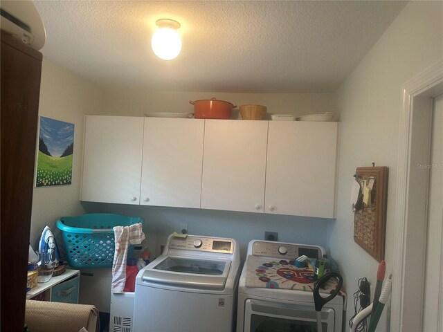 4027 Allure Ln, North Port, FL 34287 - washroom featuring cabinet space, washer and clothes dryer, and a textured ceiling