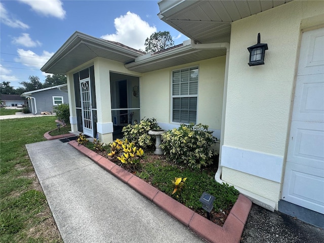4027 Allure Ln, North Port, FL 34287 - entrance to property featuring stucco siding and a yard